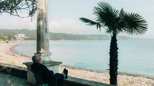 Old man sitting by the sea