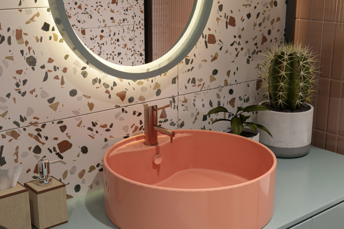 Close-up of orange sink in an eco-friendly bathroom with minimalist design and natural materials.