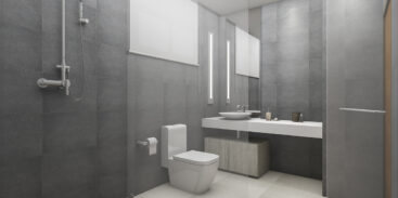 Modern loft bathroom with a toilet and shower, featuring wood flooring and contemporary fixtures.