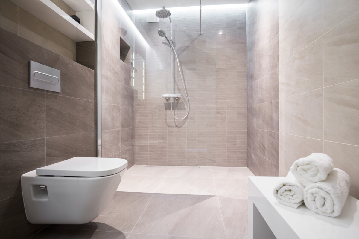 Modern shower with a glass door in a contemporary bathroom featuring clean lines and neutral tones.