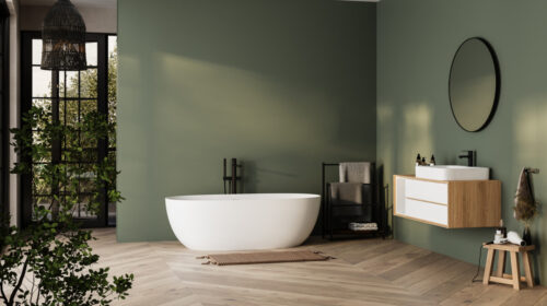 Modern green minimalist bathroom interior with a freestanding bathtub, bathroom cabinet, and white sink, featuring clean lines and neutral colours